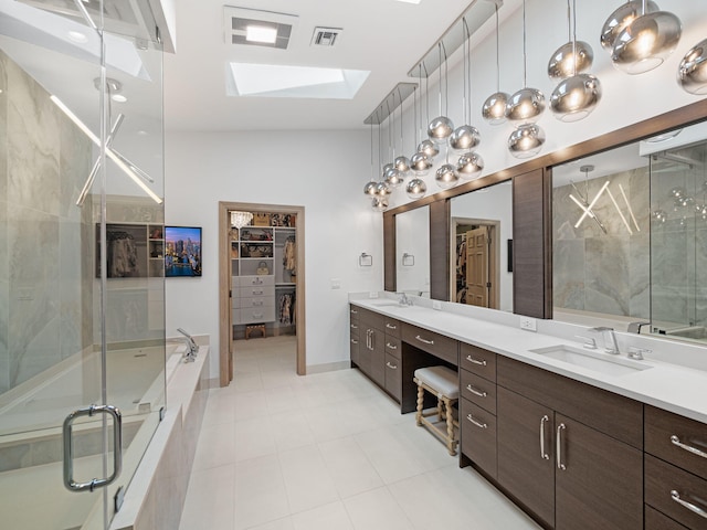 bathroom featuring high vaulted ceiling, tile patterned flooring, double sink vanity, and a skylight