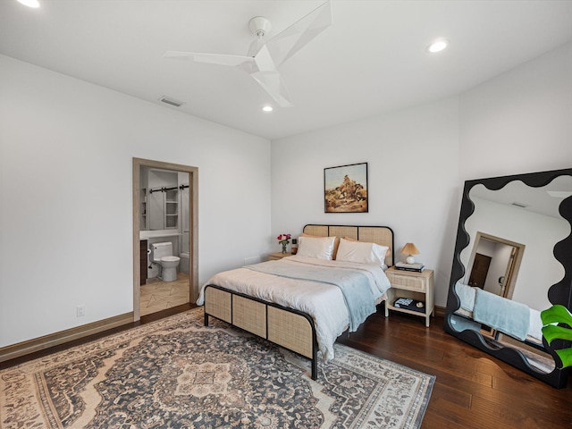 bedroom with dark hardwood / wood-style flooring, ensuite bathroom, and ceiling fan