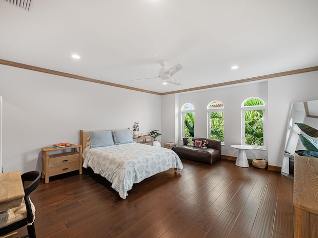 bedroom featuring dark hardwood / wood-style flooring, crown molding, and ceiling fan