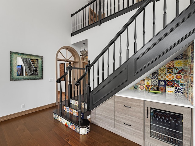 stairway featuring hardwood / wood-style floors and indoor bar