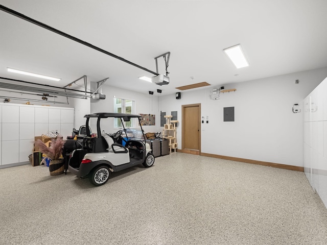 garage with a garage door opener and electric panel