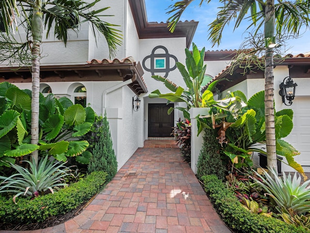 doorway to property with a garage