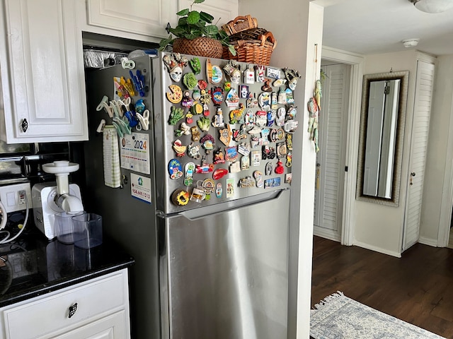 kitchen featuring stainless steel fridge, white cabinetry, and dark hardwood / wood-style flooring