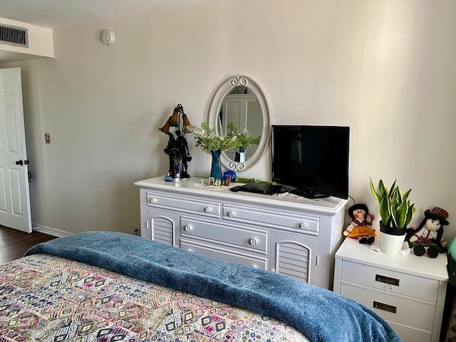 bedroom with dark wood-type flooring