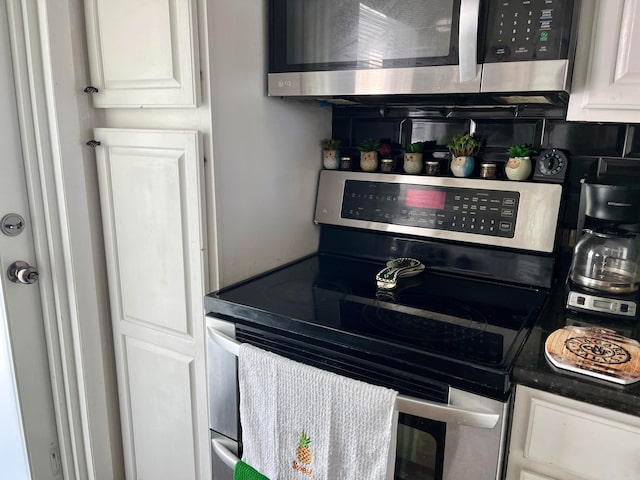 kitchen with stainless steel appliances and white cabinetry