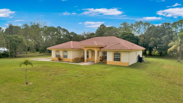 mediterranean / spanish house with a front lawn