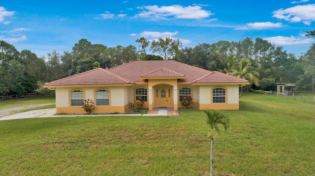 mediterranean / spanish home with a front lawn