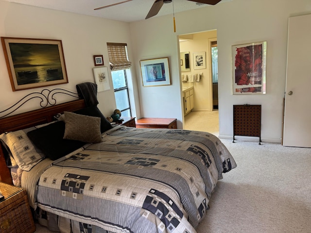 carpeted bedroom with ceiling fan and connected bathroom