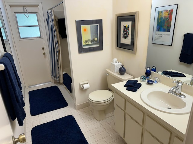 full bathroom with tile patterned flooring, shower / bath combo with shower curtain, vanity, and toilet