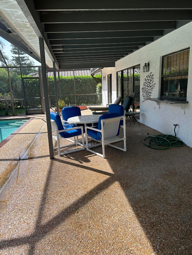 view of patio featuring a lanai