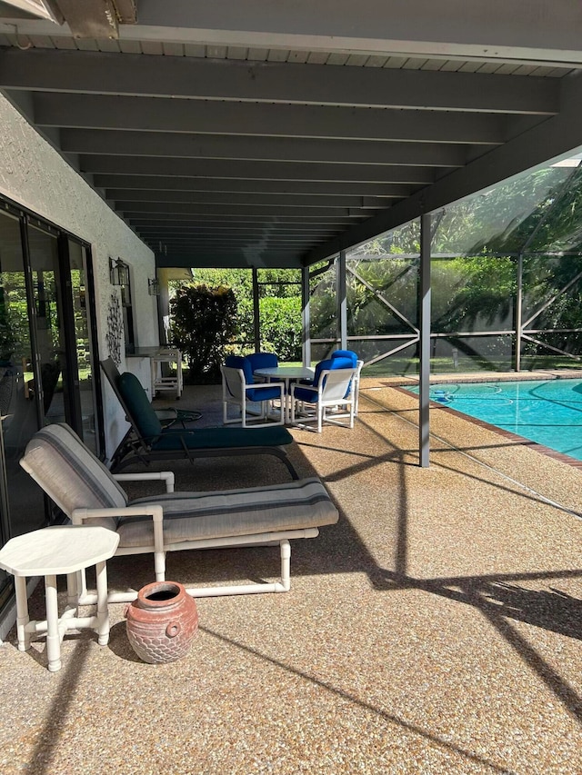 view of patio / terrace featuring a lanai