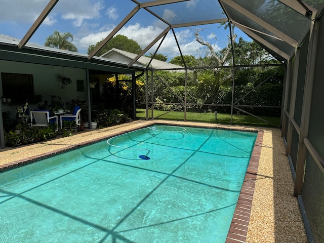 view of swimming pool with a lanai and a patio area