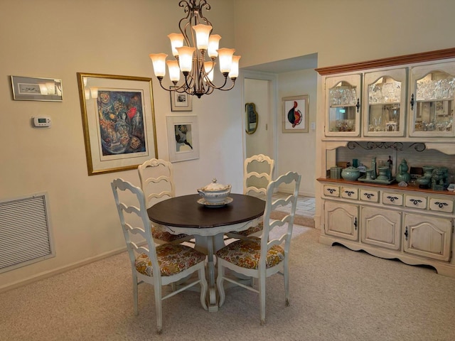 carpeted dining space featuring a chandelier