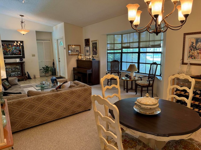 dining room featuring an inviting chandelier, carpet, and a textured ceiling