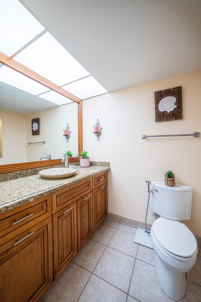 bathroom featuring vanity, toilet, and tile patterned floors