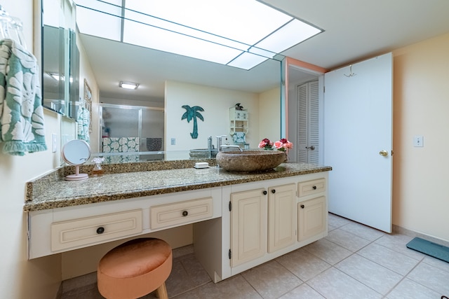 bathroom featuring vanity, an enclosed shower, and tile patterned floors