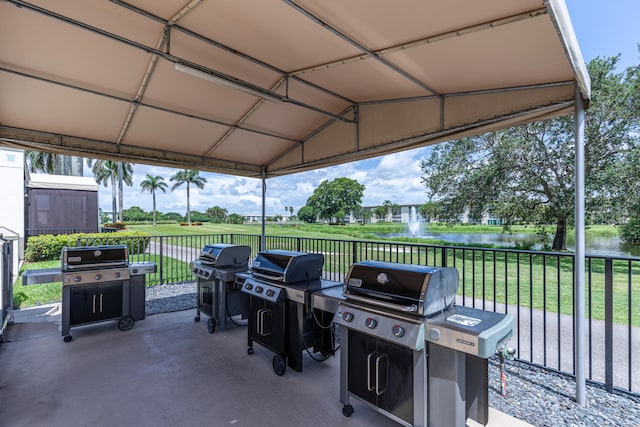 view of patio / terrace with a water view and area for grilling