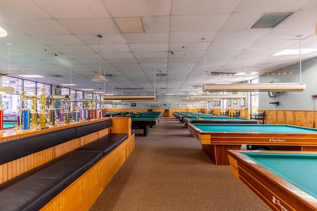 recreation room with billiards, a healthy amount of sunlight, dark colored carpet, and a drop ceiling