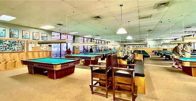 game room with wood walls and billiards