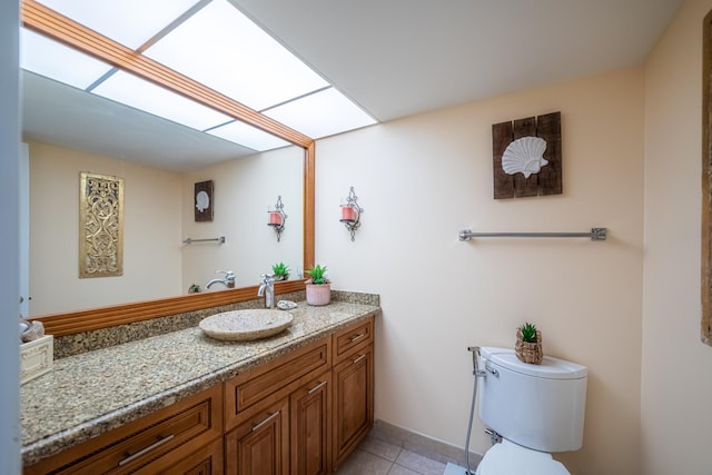 bathroom featuring vanity, toilet, and tile patterned flooring