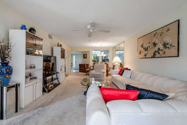 carpeted living room with a textured ceiling and ceiling fan with notable chandelier