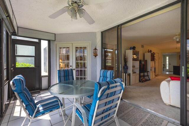 sunroom / solarium with ceiling fan and french doors