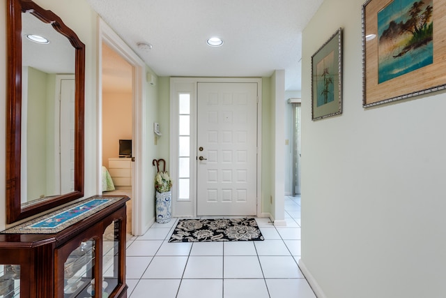 entryway featuring recessed lighting, baseboards, and light tile patterned flooring