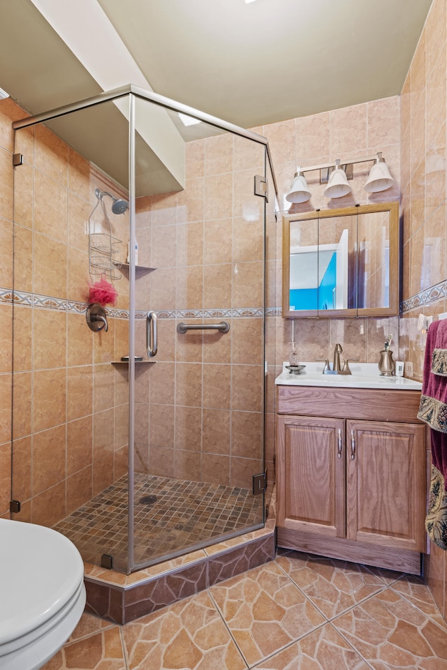 bathroom featuring an enclosed shower, tile patterned floors, vanity, tile walls, and toilet