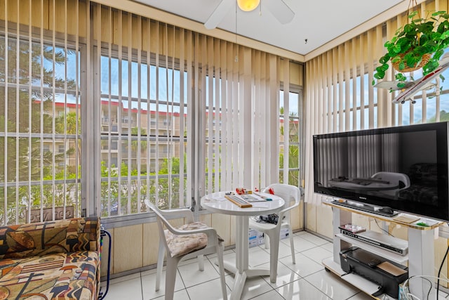 sunroom / solarium featuring ceiling fan