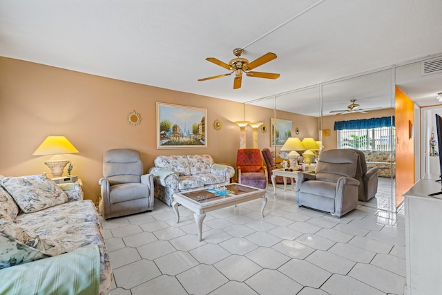 living room with ceiling fan and light tile patterned flooring