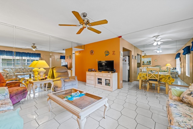 living room featuring ceiling fan and light tile patterned floors