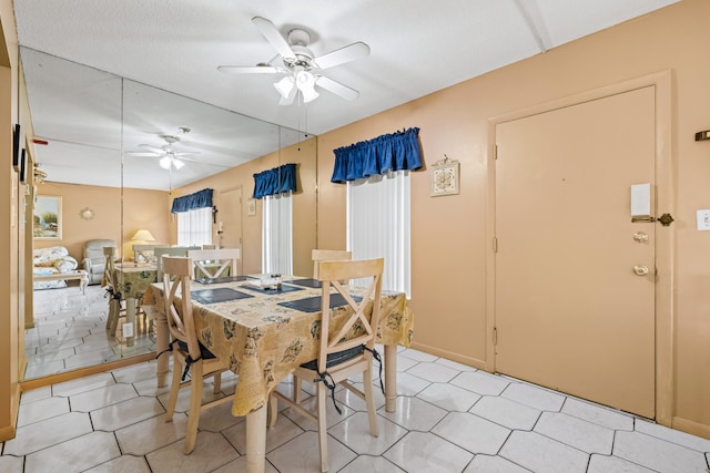 tiled dining room featuring ceiling fan