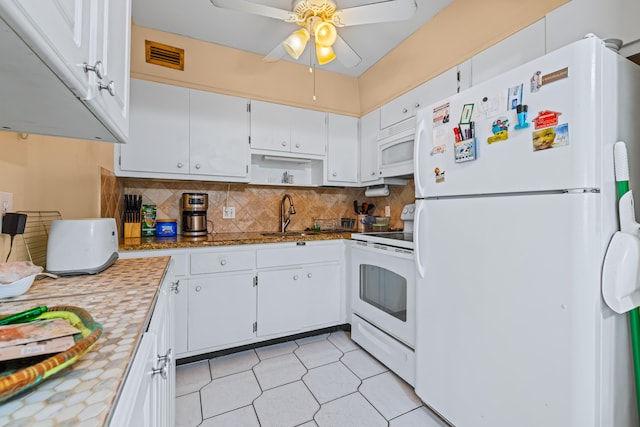 kitchen featuring ceiling fan, tasteful backsplash, white cabinetry, sink, and white appliances