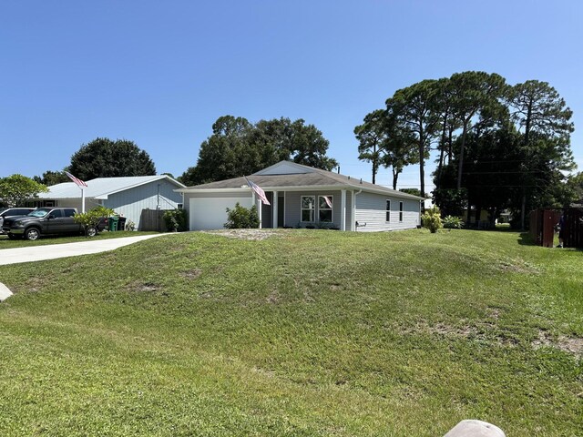 single story home featuring a garage and a front lawn