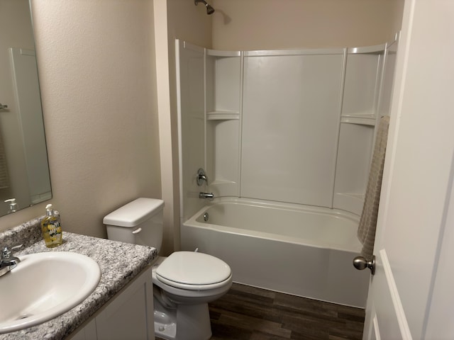 full bathroom with toilet, bathing tub / shower combination, hardwood / wood-style floors, and vanity