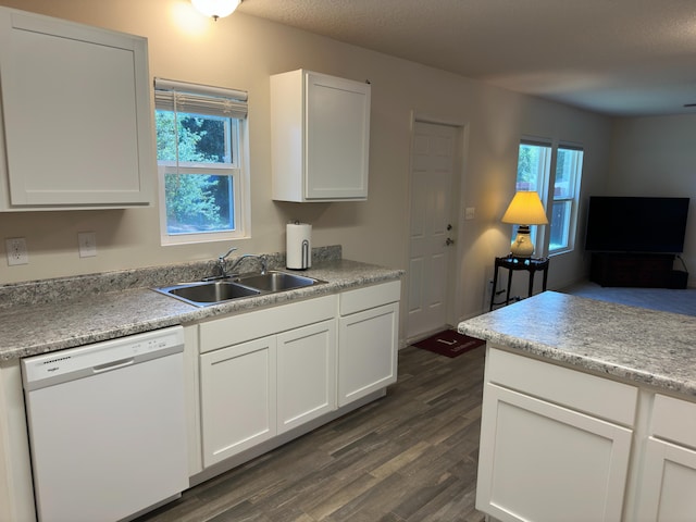 kitchen with sink, dark hardwood / wood-style floors, white cabinets, and white dishwasher