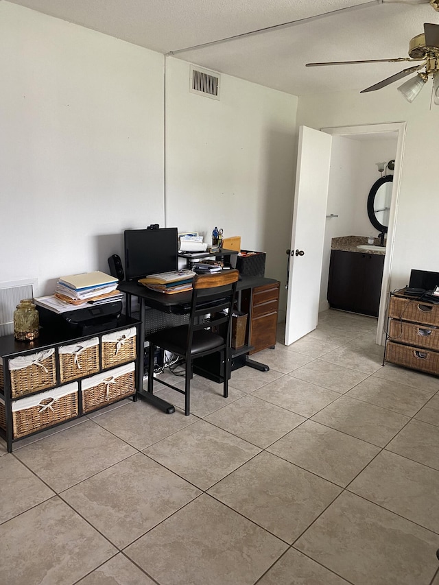 tiled office space featuring ceiling fan