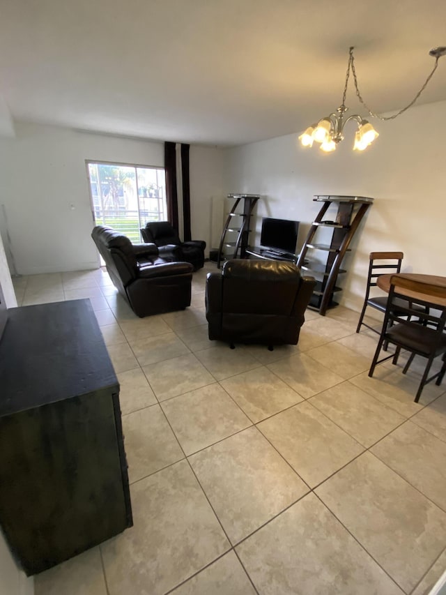 tiled living room featuring a notable chandelier