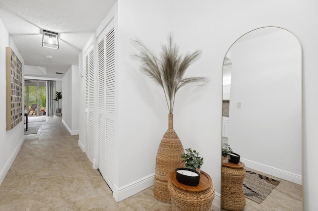 hallway featuring a textured ceiling