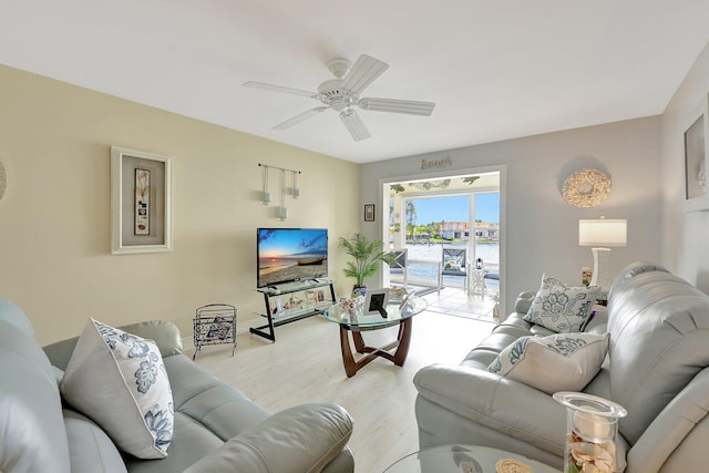 living room with ceiling fan and light hardwood / wood-style floors