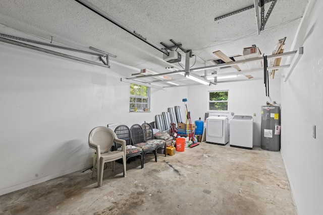 garage featuring independent washer and dryer, a garage door opener, and water heater