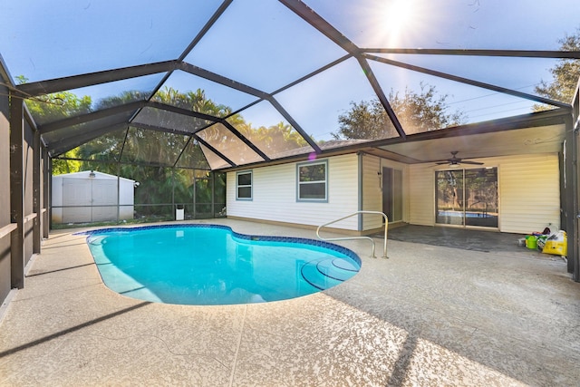 view of swimming pool featuring ceiling fan, a lanai, and a patio