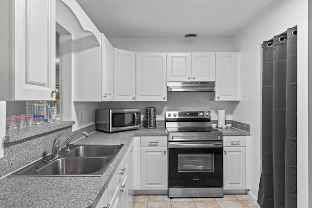 kitchen featuring light tile patterned flooring, sink, white cabinetry, and stainless steel appliances