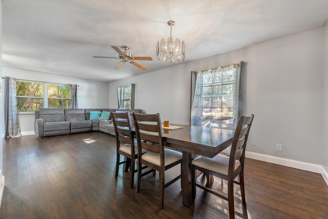 dining space featuring a textured ceiling, ceiling fan with notable chandelier, and dark hardwood / wood-style floors