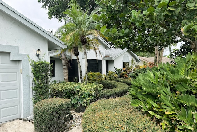 2450 Riviera Dr, Delray Beach, FL 33445 - exterior space with a garage and stucco siding