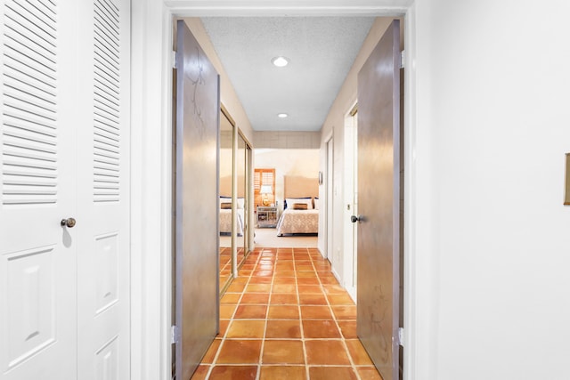 2450 Riviera Dr, Delray Beach, FL 33445 - hallway with light tile patterned floors, recessed lighting, and a textured ceiling