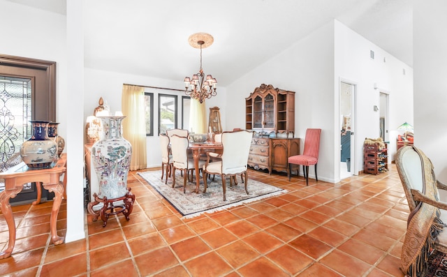 dining area with tile patterned flooring and a chandelier