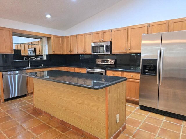 2450 Riviera Dr, Delray Beach, FL 33445 - kitchen with a sink, tasteful backsplash, stainless steel appliances, light tile patterned flooring, and lofted ceiling