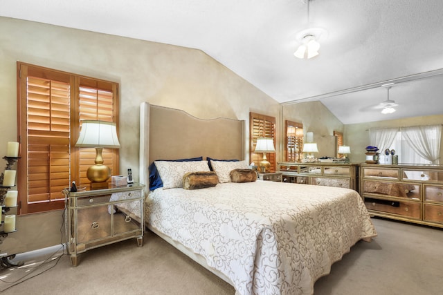 carpeted bedroom with lofted ceiling