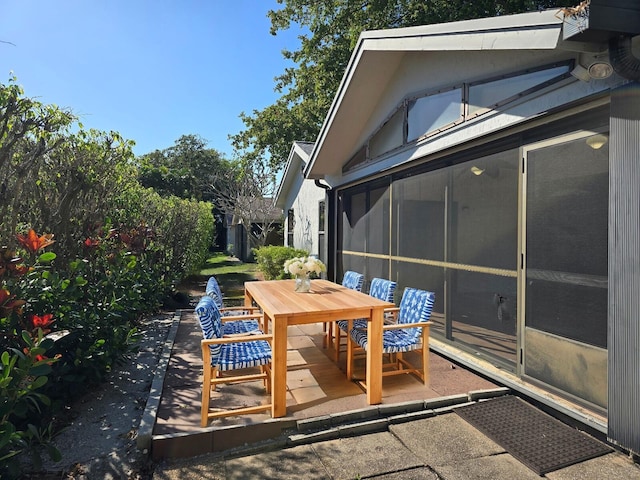 2450 Riviera Dr, Delray Beach, FL 33445 - view of patio / terrace with outdoor dining space and a sunroom